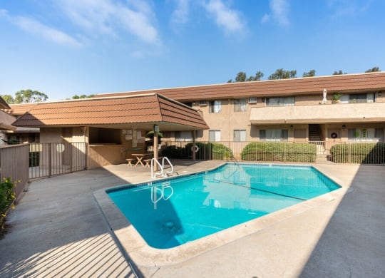 a swimming pool in front of a hotel with a building at North View Terrace, Montebello