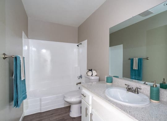 a bathroom with a sink toilet and a mirror at North View Terrace, Montebello, CA
