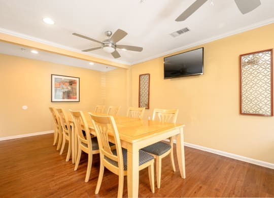 a dining room with a table and chairs and a flat screen tv