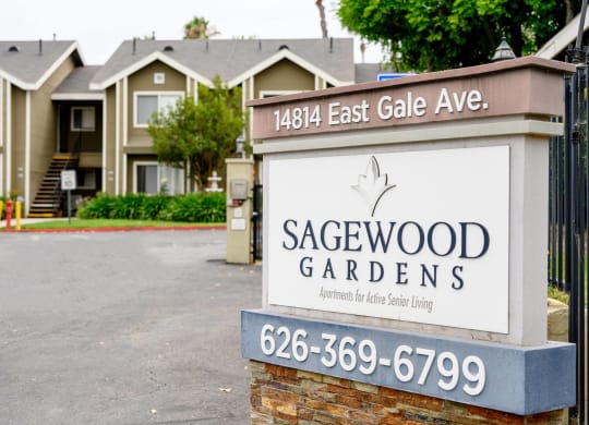 a sign in front of houses at Sagewood Gardens Senior Apartments, Hacienda Heights California