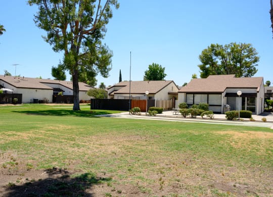a row of houses with a large yard in the foreground at Villa Hemet, Hemet California
