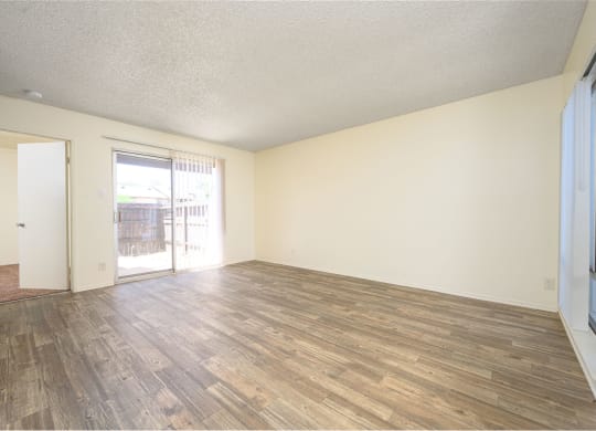a bedroom with hardwood floors and white walls at Villa Hemet, California, 92543