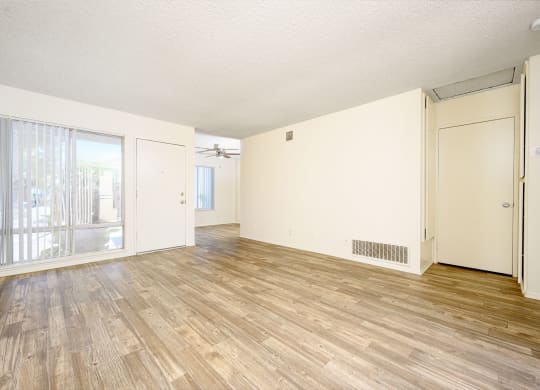 a bedroom with hardwood floors and white walls at Villa Hemet, Hemet