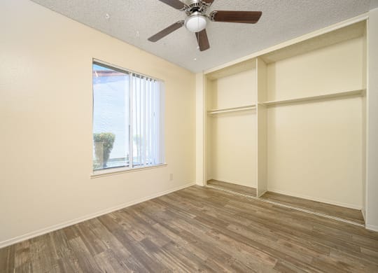 a bedroom with a large window and a ceiling fan at Villa Hemet, California