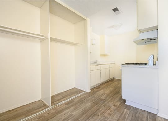 a kitchen with white walls and wood flooring at Villa Hemet, California