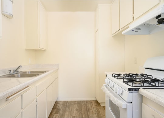 a kitchen with white cabinets and a white stove top oven at Villa Hemet, Hemet, CA 92543