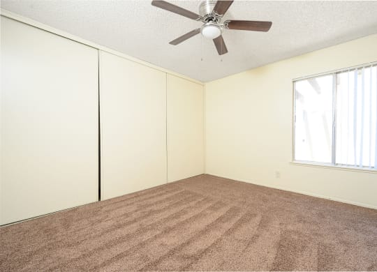 a bedroom with white walls and a ceiling fan at Villa Hemet, Hemet, 92543