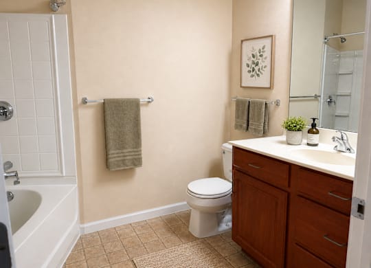 A bathroom with a toilet, sink, and towel rack.