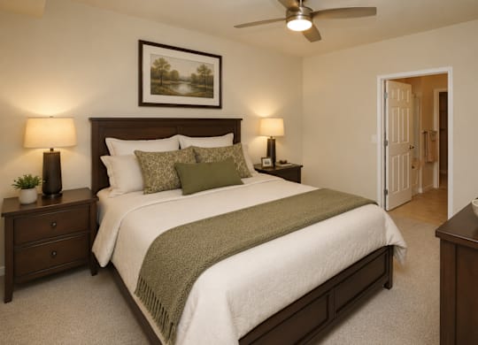 A bedroom with a bed, nightstands, and a ceiling fan.