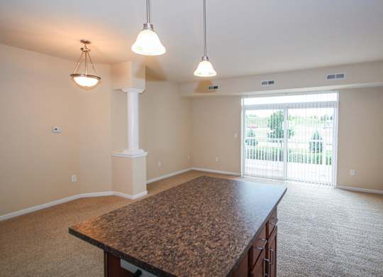 a kitchen and living room with a large sliding glass door