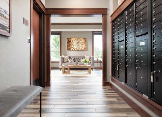 a hallway with mailboxes leading to a common area  at Victoria Park and V2 Apartments, St. Paul, MN