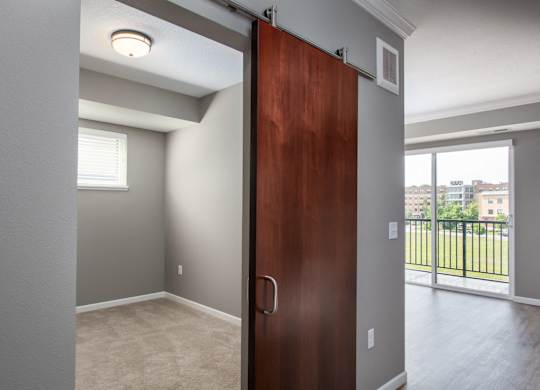 a bedroom with a sliding door  at Victoria Park and V2 Apartments, St. Paul