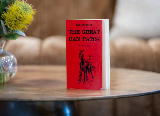 A red book titled The Story of the Great Dan Patch sits on a table.