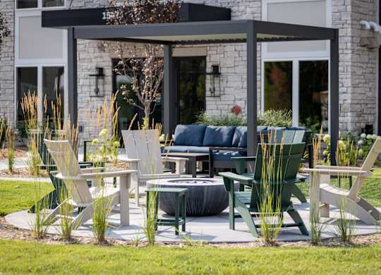 A patio with a table and chairs is set up outside a house.