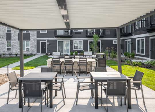 A patio with a table and chairs is set up outside a building.