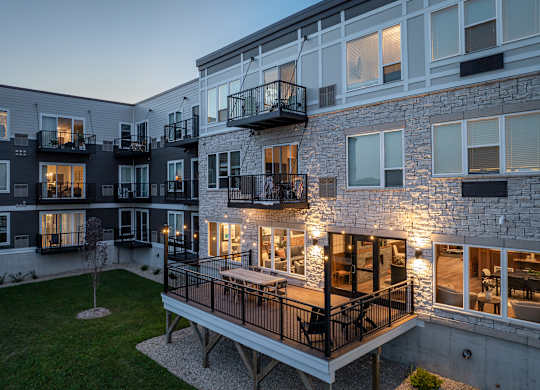 A modern apartment building with balconies and a courtyard.