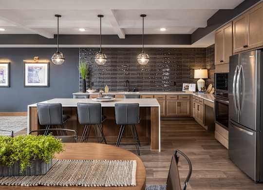 A modern kitchen with a dining table and chairs.