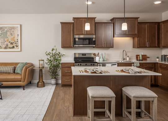 A kitchen with a couch and bar stools.
