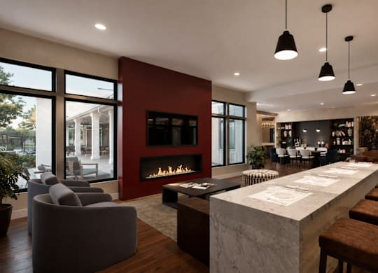 A modern living room with a fireplace and a long table.