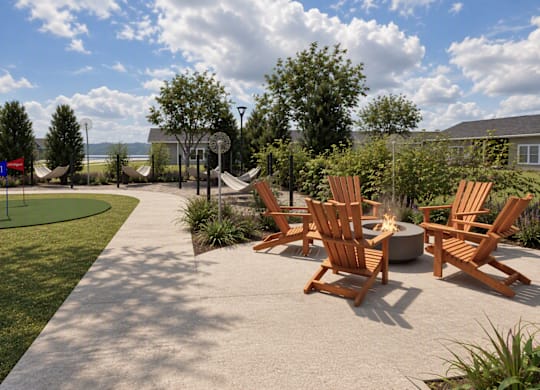 A patio with a fire pit and chairs.