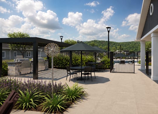 A patio area with a table and chairs under a gazebo.