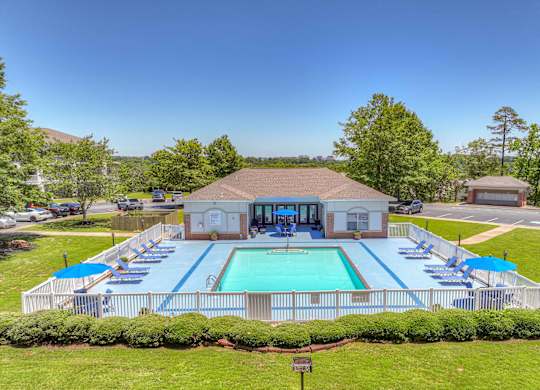 A pool with a building behind it.