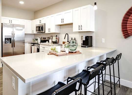 Brand new modern studio, one and two-bedroom apartment homes featuring stainless steel appliances, tile backsplash, quartz countertops, LVP flooring, large picture windows, in-unit washer and dryer and balconies at The Artisan at 39th in Omaha, NE