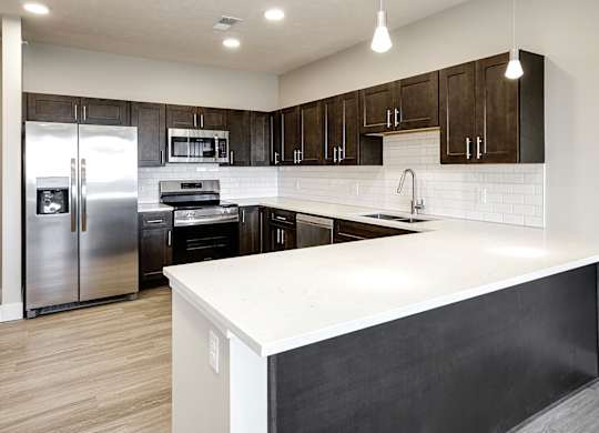 Brand new modern studio, one and two-bedroom apartment homes featuring stainless steel appliances, tile backsplash, quartz countertops, LVP flooring, large picture windows, in-unit washer and dryer and balconies at The Artisan at 39th in Omaha, NE