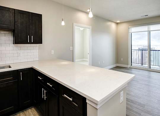 Brand new modern studio, one and two-bedroom apartment homes featuring stainless steel appliances, tile backsplash, quartz countertops, LVP flooring, large picture windows, in-unit washer and dryer and balconies at The Artisan at 39th in Omaha, NE