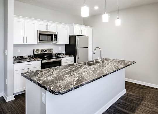 Kitchen island at Deerfield Apartments and Chateaus in Fremont, NE