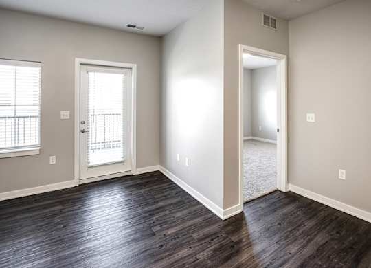 Living Room with balcony at Deerfield Apartments and Chateaus in Fremont, NE