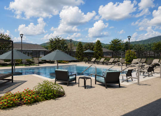 A pool area with sun loungers and umbrellas.