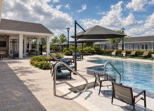 A poolside area with a hot tub and lounge chairs.