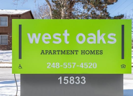 a sign for west oaks apartment homes