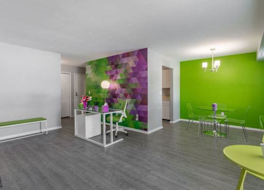 a room with a green wall and a white table and chairs
