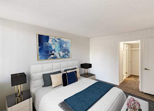 A bedroom with a large bed and a painting on the wall at The Waverly on the Lake - Belleville, MI Apartment , Belleville, 48111