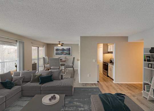 A living room with a grey couch and a coffee table at The Waverly on the Lake - Belleville, MI Apartment, Belleville, MI, 95050
