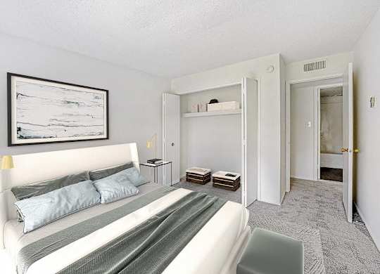 A bedroom with a bed, nightstands, and a painting on the wall at The Waverly on the Lake - Belleville, MI Apartment, Belleville, MI, 95050