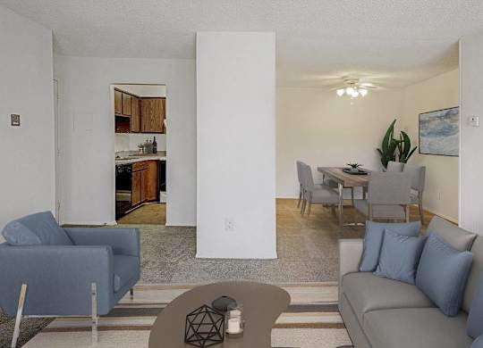 A living room with a grey couch and a blue chair at The Waverly on the Lake - Belleville, MI Apartment , Belleville, 95050