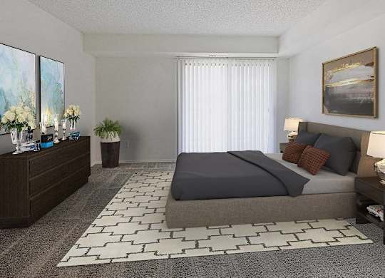 A bedroom with a large bed, a nightstand with a lamp, and a painting on the wall at The Waverly on the Lake - Belleville, MI Apartment , Belleville, 95050