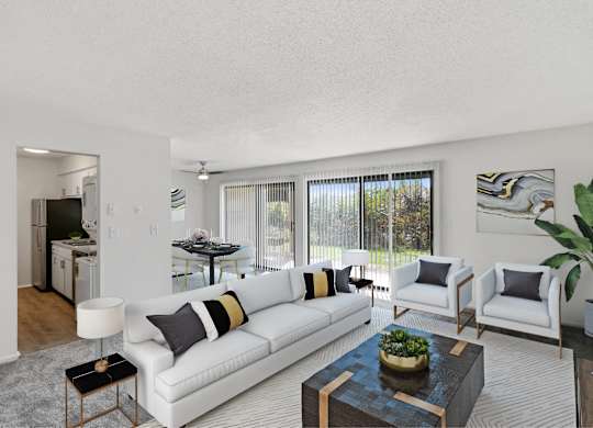 A living room with a white couch, a coffee table, and a potted plant at The Waverly on the Lake - Belleville, MI Apartment, Belleville, MI, 95050