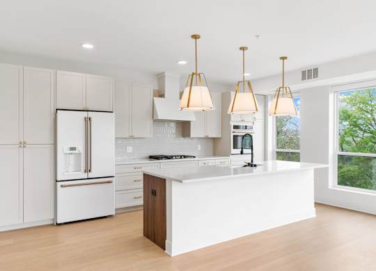 A modern kitchen with white cabinets and a central island.