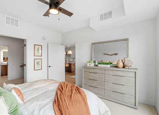 A bedroom with a queen-sized bed in a one-bedroom, one-bathroom apartment home at Lilia in Lilydale, MN 55118