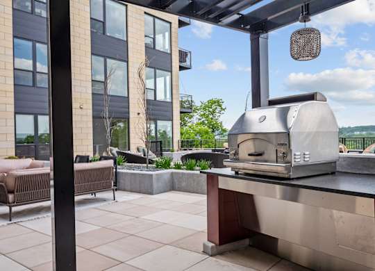 Zen Terrace with Lounge Chairs and Grills at Lilia Apartments in Lilydale, MN 55118