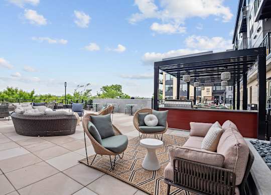 Outdoor Pooldeck and Spa with Grills and Lounge Chairs at Lilia Apartments in Lilydale, MN 55118