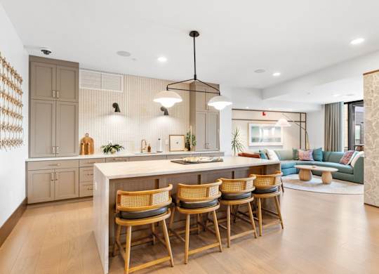 The kitchen and lounge spaces in the Clubroom, a reservable community room at Lilia in Lilydale, MN 55118