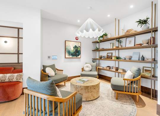 Comfortable seating in the Clubroom, a reservable community amenity at Lilia in Lilydale, 55118