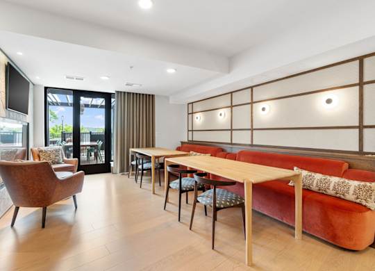 Bench seating across from the fireplace in the Clubroom, a reservable community room at Lilia in Lilydale, MN 55118