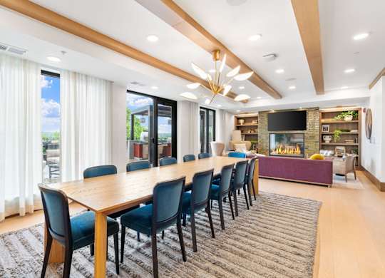 The long dining table overlooking the seating and fireplace in the Private Dining Room, a reservable community room at Lilia in Lilydale, MN 55118