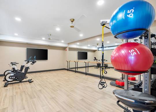 The spin and yoga studio attached to the resort-style luxury 24-hour fitness center at Lilia in Lilydale, MN 55118, with cardio equipment, free weights, and exercise machines.